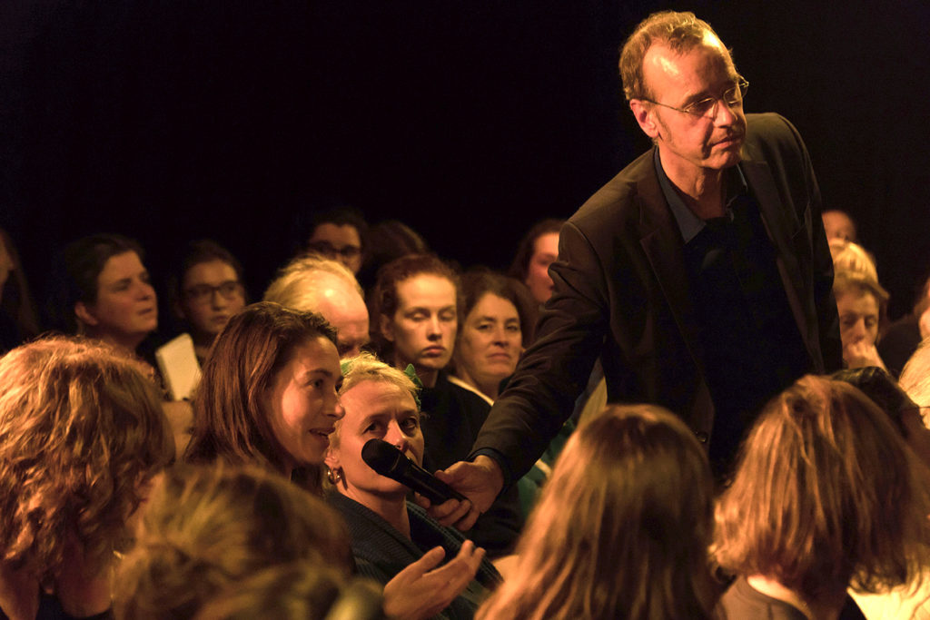 Marq Wijngaarden (Modrator) taking public question at 'Refugee on Trial' performance art by Ehsan Fardjandiya